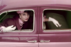 Model Marie-Hélene Arnaud poses in a pink car for Vogue, August 1957.
